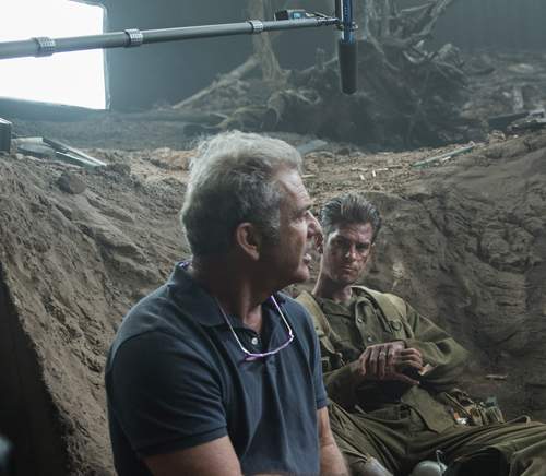 Director Mel Gibson on set with Andrew Garfield, who plays Doss